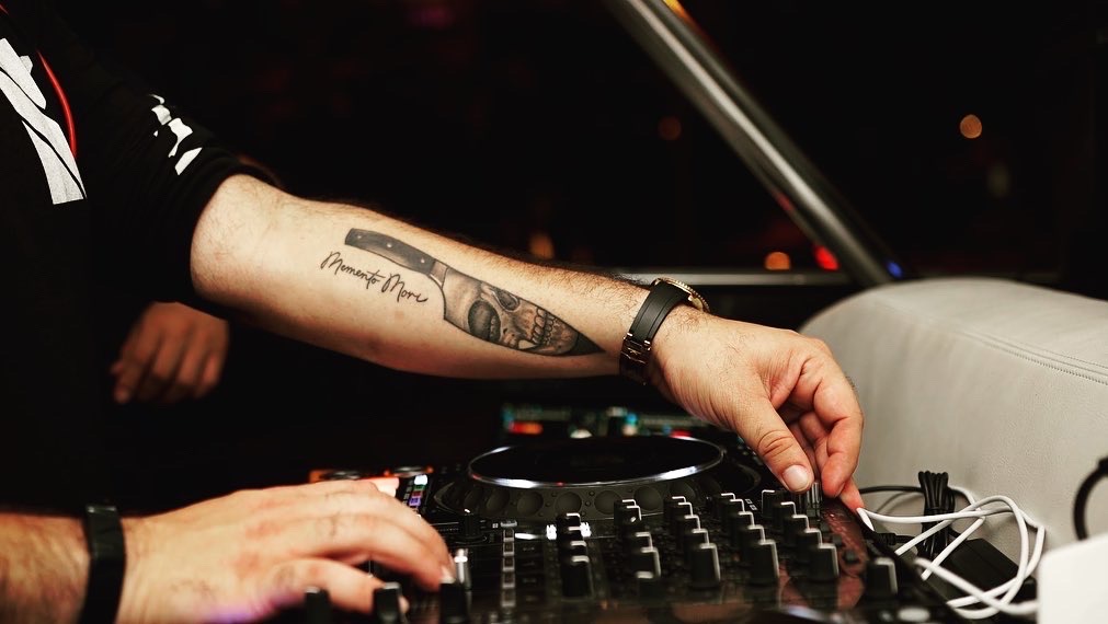 Hands mixing on DJ equipment